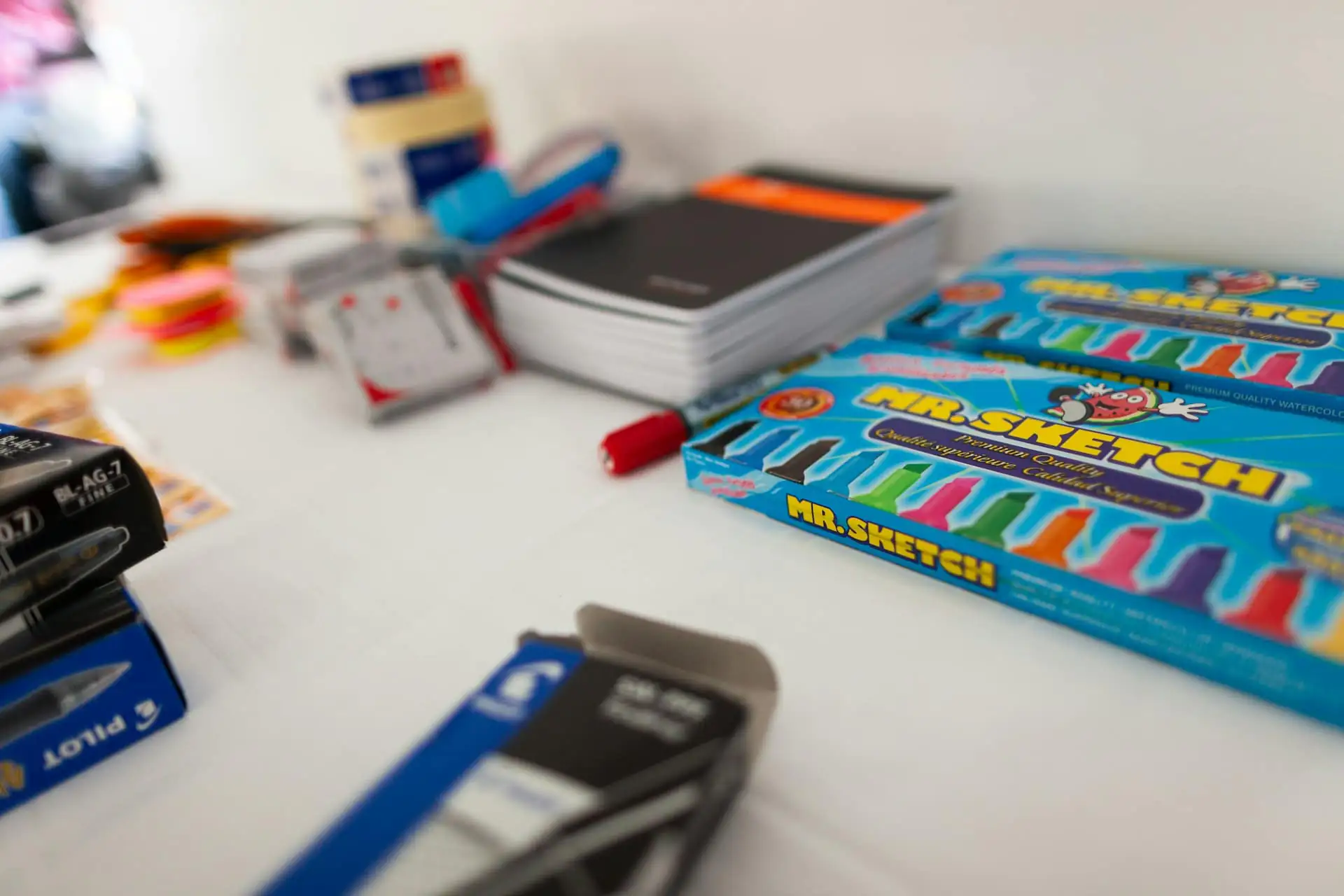 Primary school books and colourful stationery on a desk