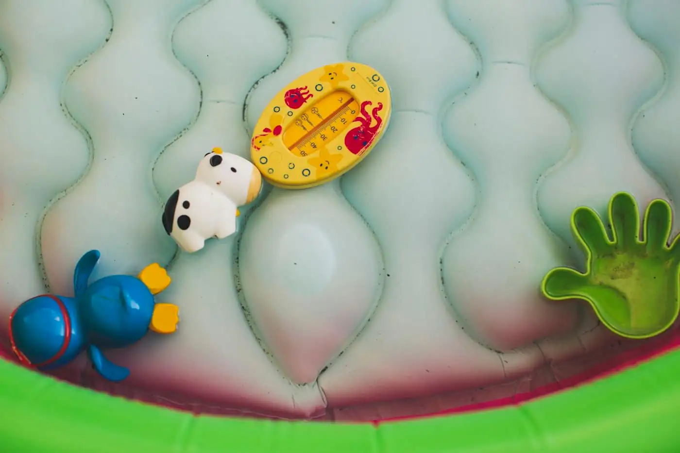 Colourful water play toys on a splash wall